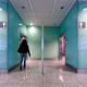 A woman walks into a public restroom.