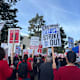 Students and faculty at San Francisco State University hold signs at a strike to demand pay raises for staff on December 6, 2023.