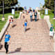 The location is University of California, Los Angeles. Large groups of students walking down the stairs