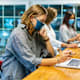 College Students Wearing Face Masks Working Together in a Computer Lab