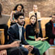 Diverse group of college students having a discussion in a seminar class on campus.