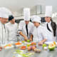 A group of individuals participating in a cooking class at the culinary school