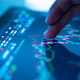 Businessman checking stock market data on tablet