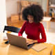 Woman typing on laptop at home