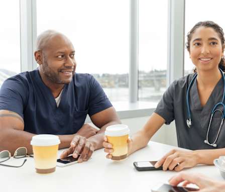 Nurses talking to each other at a cafe table