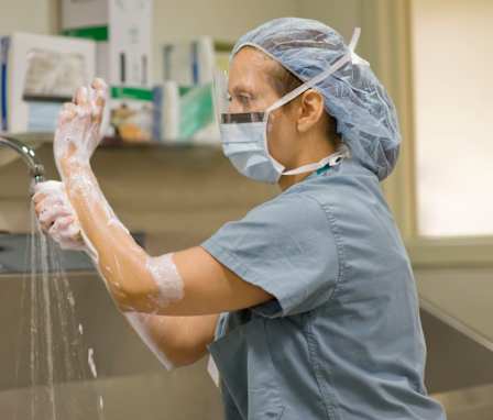 Surgical nurse scrubbing hands