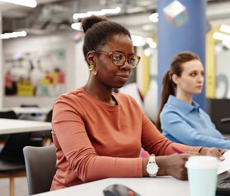 Two nursing students taking NCLEX exam in computer lab