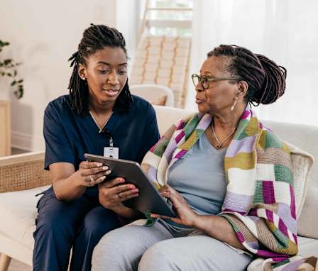 Public health RN helping patient in her home