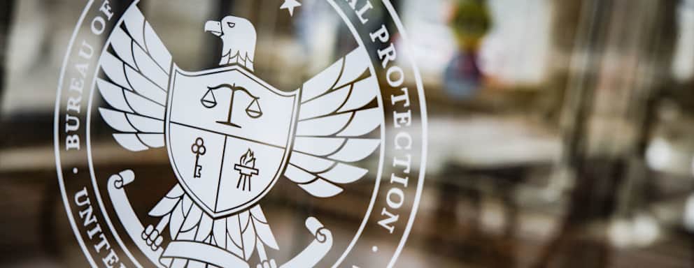 A seal at the Consumer Financial Protection Bureau (CFPB) headquarters in Washington, D.C., U.S., on Saturday, April 16, 2022. The Credit-reporting company TransUnion is an "out-of-control" repeat offender engaging in deceptive marketing practices the CFPB alleged this week after filing a lawsuit. Photographer: Samuel Corum/Bloomberg via Getty Images