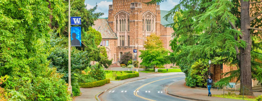 Student walks on the University of Washington campus in Seattle Washington USA on a cloudy day.