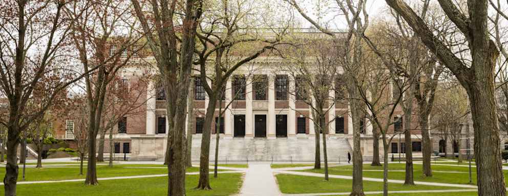 Pedestrians walk through Harvard Yard on the closed Harvard University campus in Cambridge, Massachusetts, U.S., on Monday, April 20, 2020. College financial aid offices are bracing for a spike in appeals from students finding that the aid packages they were offered for next year are no longer enough after the coronavirus pandemic cost their parents jobs or income. Photographer: Adam Glanzman/Bloomberg via Getty Images