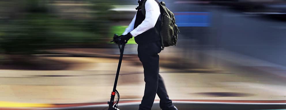 BOSTON - AUGUST 13: A man cruises on a motorized scooter along Commonwealth Avenue in Boston on Aug. 13, 2020. (Photo by Jim Davis/The Boston Globe via Getty Images)