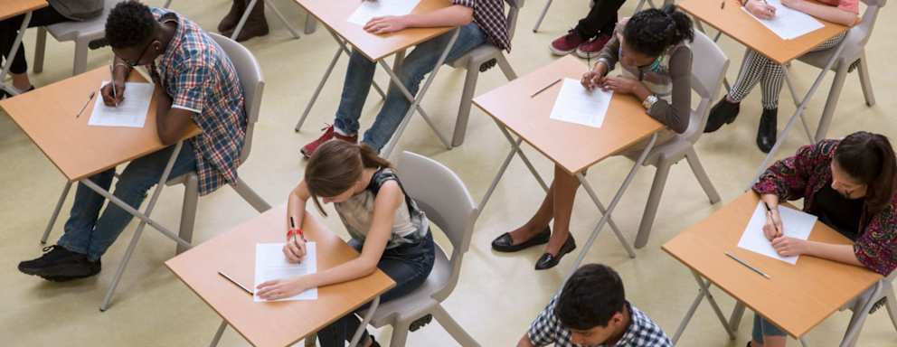 Overhead view of a classroom full of high school students taking the ACT test.