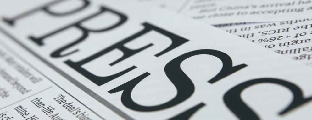 A close up picture of the word "Press" written atop a newspaper page.