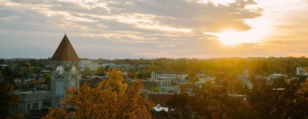 bird's-eye view of the City of Bloomington, Indiana and the campus of Indiana University with sunset in fall