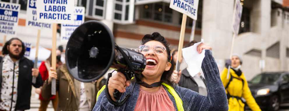 Los Angeles, CA - December 01:Gloria Bartolo, a 2nd year molecular biology PhD student, leads marching UCLA postdoctoral scholars and academic researchers in Westwood as they demand better wages, student housing, child care and more with University of California on Thursday, December 1, 2022 as contract negotiations continue and thousands strike. (Photo by Sarah Reingewirtz/MediaNews Group/Los Angeles Daily News via Getty Images)
