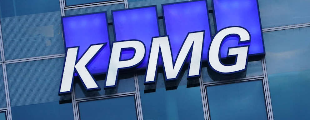 BERLIN, GERMANY - JANUARY 22: The logo of KPMG, a multinational tax advisory and accounting services company, hangs on the facade of a KPMG offices building on January 22, 2021 in Berlin, Germany. KPMG has come under the spotlight in Germany due to the company's role in the current Wirecard scandal. (Photo by Sean Gallup/Getty Images)