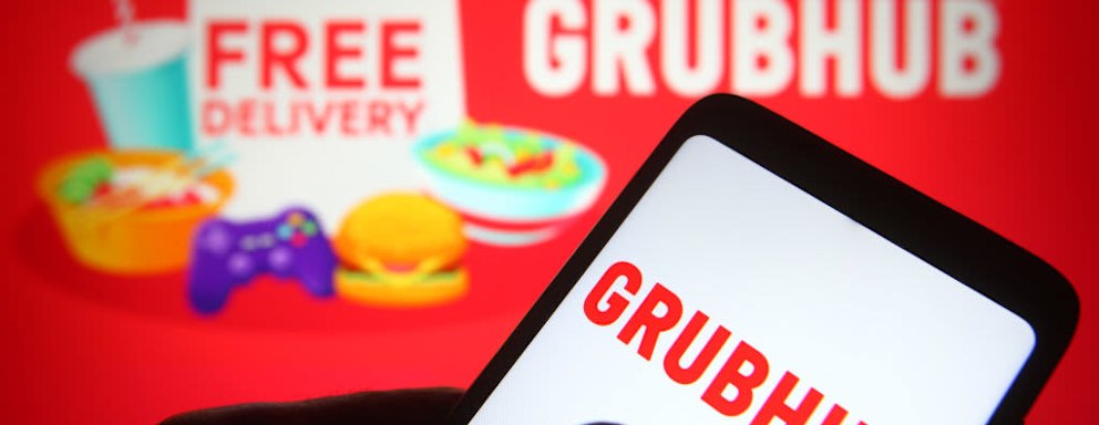 UKRAINE - 2021/06/04: In this photo illustration, Grubhub logo of a US online and mobile prepared food ordering and delivery platform is seen on a smartphone in a hand. (Photo Illustration by Pavlo Gonchar/SOPA Images/LightRocket via Getty Images)