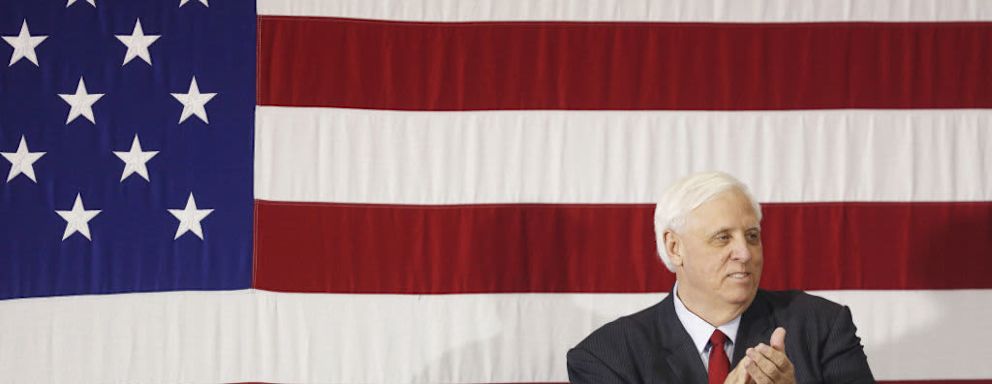 Jim Justice, governor of West Virginia, applauds on stage before participating in a round table discussion on tax reform with U.S. President Donald Trump, not pictured, at the White Sulphur Springs Civic Center in White Sulphur Springs, West Virginia, U.S., on Thursday, April 5, 2018. Trump revisited remarks he made about Mexican "rapists" crossing the U.S. border when he announced his run for president and assailed the nation's immigration laws in a speech on Thursday that was supposed to focus on his tax law. Photographer: Luke Sharrett/Bloomberg via Getty Images