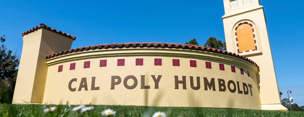 Photo of a sign on Cal Poly Humboldt campus that ssays "Cal Poly Humboldt".
