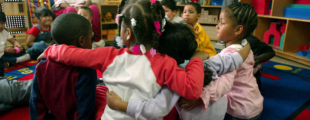 Children (ages 35 y]ears old) who are participating in the Head Start Program at the Kedren Community Health Center in Watts link arms before they go outside for recess on 1/30/03. The Center is part of the Head Start Program and a Bush administration plan to give standardized reading and math test to 500,000 lowincome preschooler belonging to the national Head Start program has been met with deep skepticism. The 1/2 billion dollar program serves 900,000 children nationwide, 60% of whom are four year olds that are targeted for the test. KIDS DURING THE HEAD START PROGRAM ARE PHOTOGRAPHED ON 1/30/03. (Photo by Gary Friedman/Los Angeles Times via Getty Images)