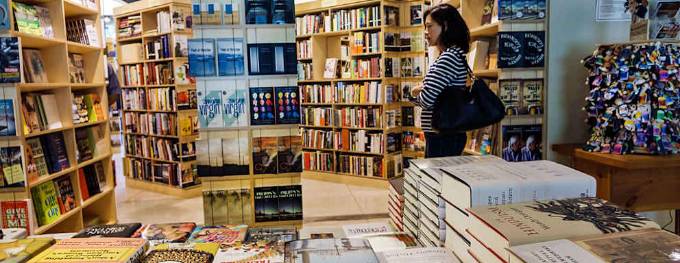 A woman looking at books in the Seminary Co-op Bookstores at University of Chicago. (Photo by: Jeffrey Greenberg/Universal Images Group via Getty Images)