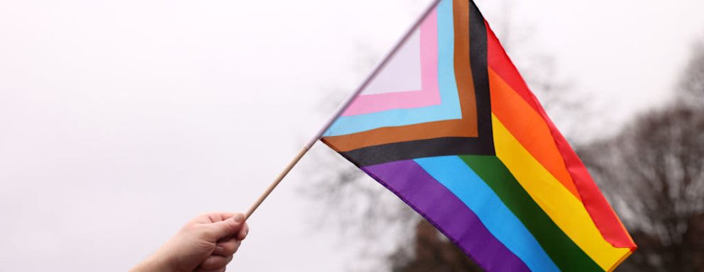 Boston, MA - March 31: A person waves a Pride flag during a Transgender Day of Visibility Event named, We Are A State of Love: A Gathering of Visible Solidarity With LGBTQ Youth outside of the State House in Boston on March 31, 2022. (Photo by Jessica Rinaldi/The Boston Globe via Getty Images)