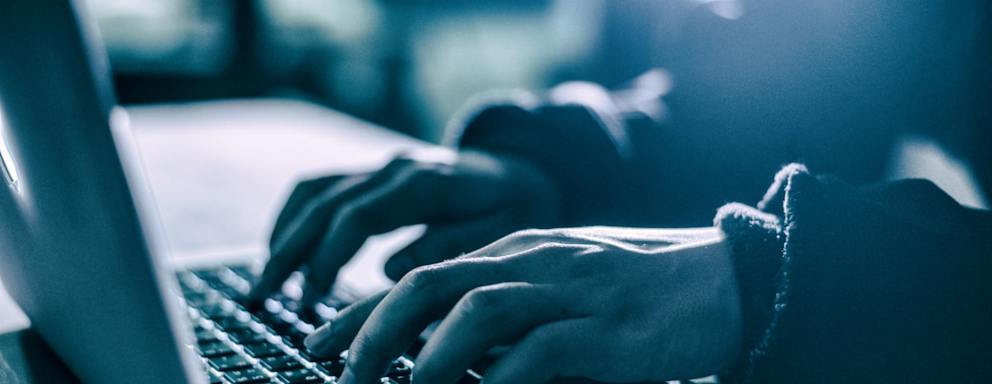 Hacker using laptop. Hacking the Internet.