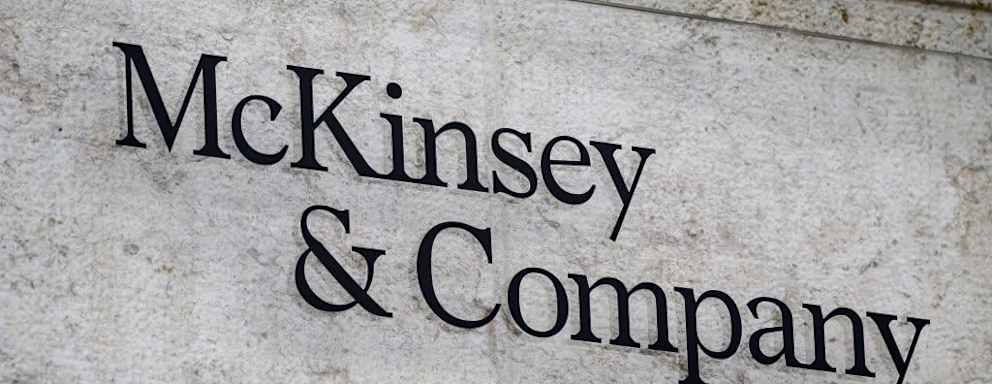 US-based McKinsey & Company's logo inn a sign on the exterior of a building.