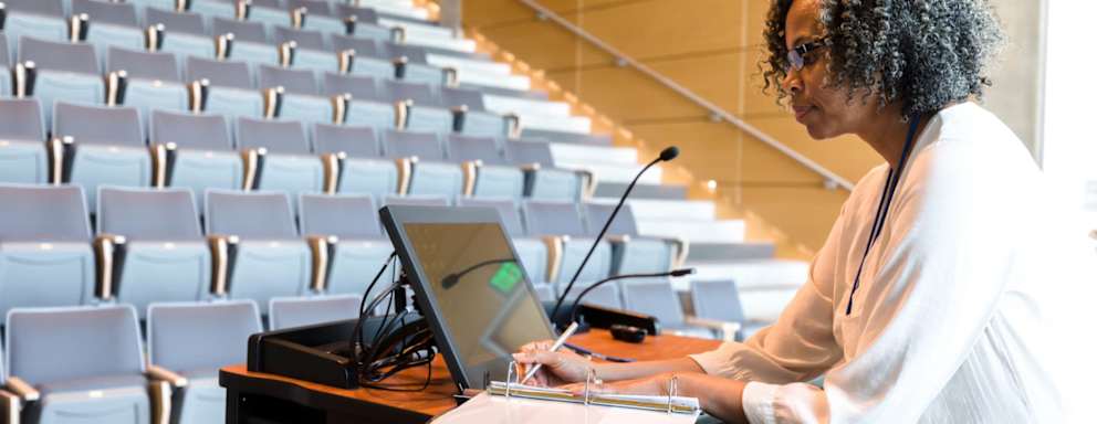 Mature female college professor preparing for lecture