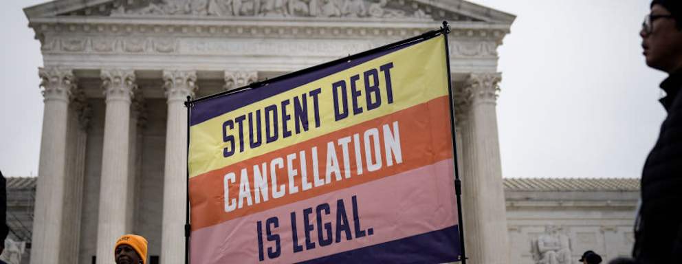 People rally in support of the Biden administration's student debt relief plan in front of the U.S. Supreme Court on February 28, 2023 in Washington, DC. Students are carrying signs that read, "Student debt cancellation in legal."