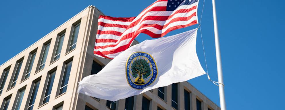 Flags for the U.S. and the U.S. Department of Education fly outside the Department of Education building in Washington, D.C.