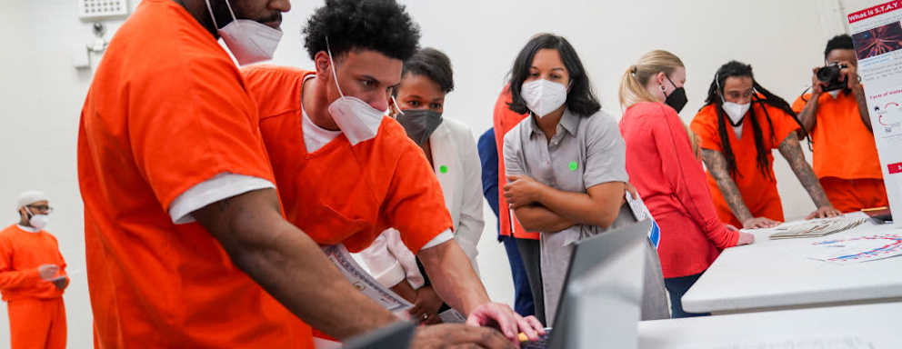 Students from the Brave Behind Bars program, an introductory computer science program for incarcerated people, gather for graduation at the DC Jail