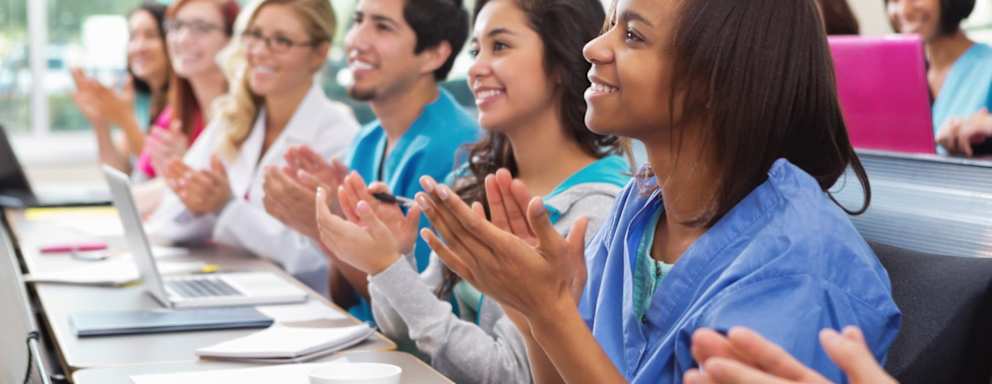 Nursing students clapping during a lecture