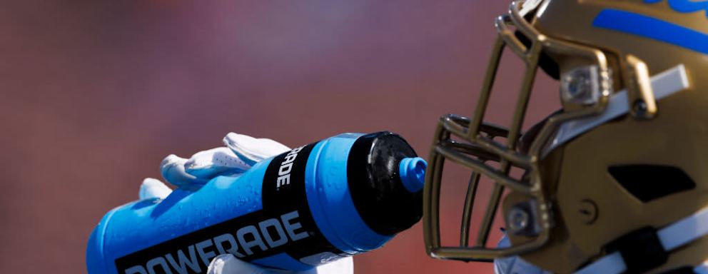 Detail view of a UCLA player drinking Powerade during the college football game