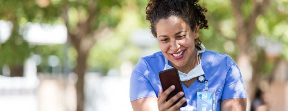 Nurse outside of hospital talking on phone
