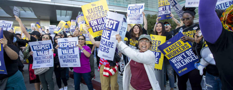 Kaiser Permanente healthcare workers holding signs on picket line