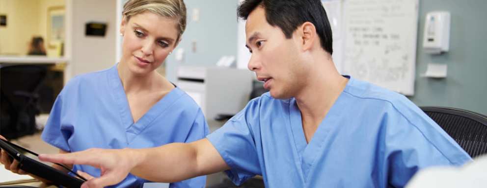Nurses planning shifts at nurse's station