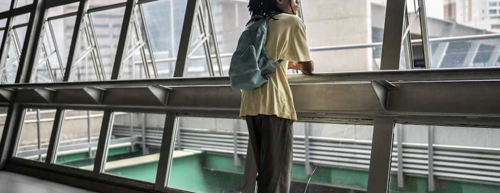 Student looking outside from city walkway