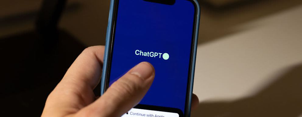 A ChatGPT iOS App logo displayed on a smartphone.