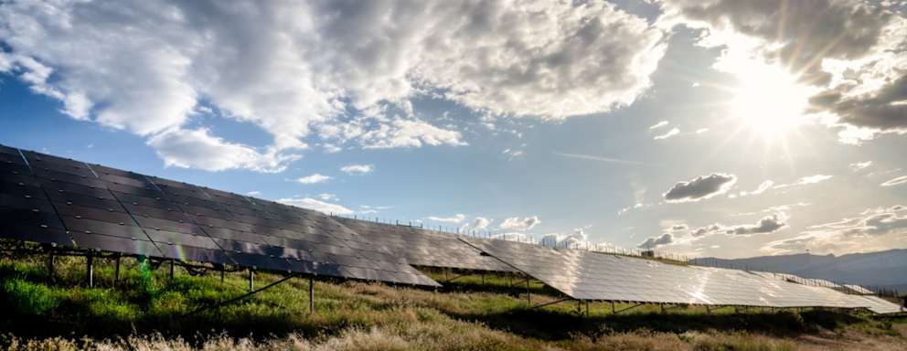 A beautiful blue sky and cloudscape around sunset at a solar farm in Western Colorado.