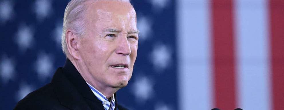 President Biden speaking in front of an American flag