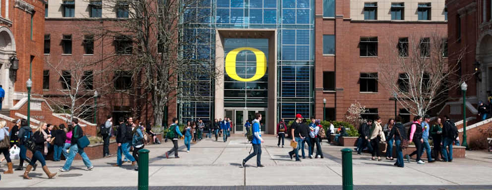 Students walk to classes on the University of Oregon campus in Eugene, Oregon, on a sunny April day.