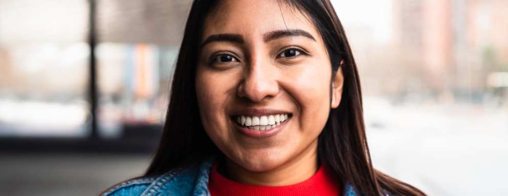 Female Native American college student smiling at the camera.
