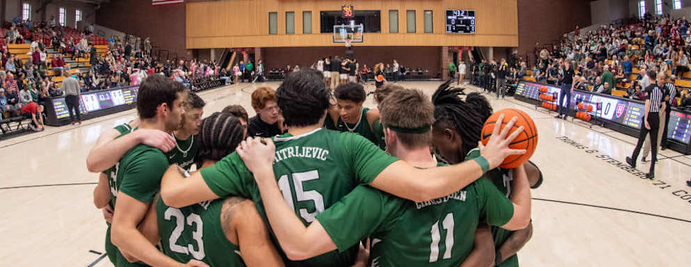 Dartmouth Big Green players huddle as a team before the college basketball game between the Dartmouth Big Green and the Harvard Crimson