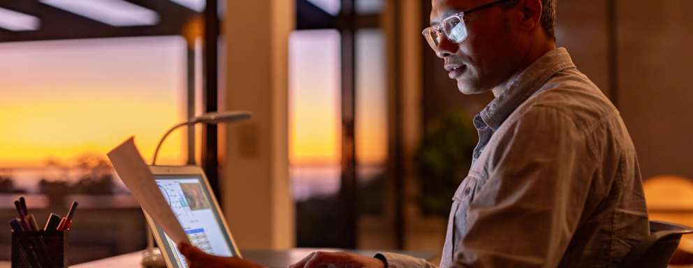 Man working on laptop from home at night
