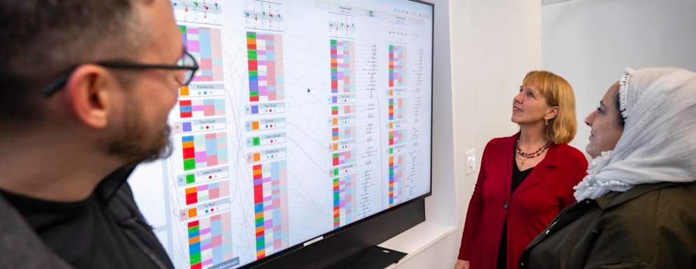 Students analyzing AI-generated data responses with computer science professor Elke Rundensteiner at Worcester Polytechnic Institute.