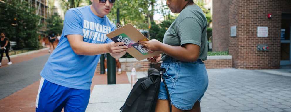 Coby Rich, a junior at the University of Pennsylvania, helps Makayla Davis, a 2nd year masters student, register to vote in Pennsylvania during a voter drive on campus in Philadelphia, Pennsylvania on August 31, 2022. The voter drive was for All in PA, a campaign from Pennsylvania Dems to register new voters in Pennsylvania.