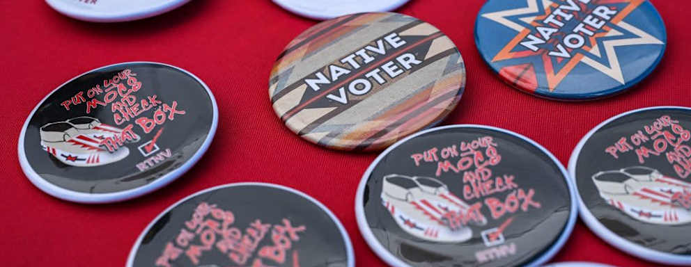 Pins from the Rock the Native Vote campaign with messages like "Native Voter" laid out on a display table during a cultural meeting at the Comanche Nation fairgrounds in Lawton, Oklahoma on September 30, 2023.