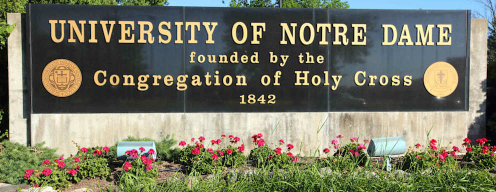 Daytime view of the University of Notre Dame campus entrance sign.